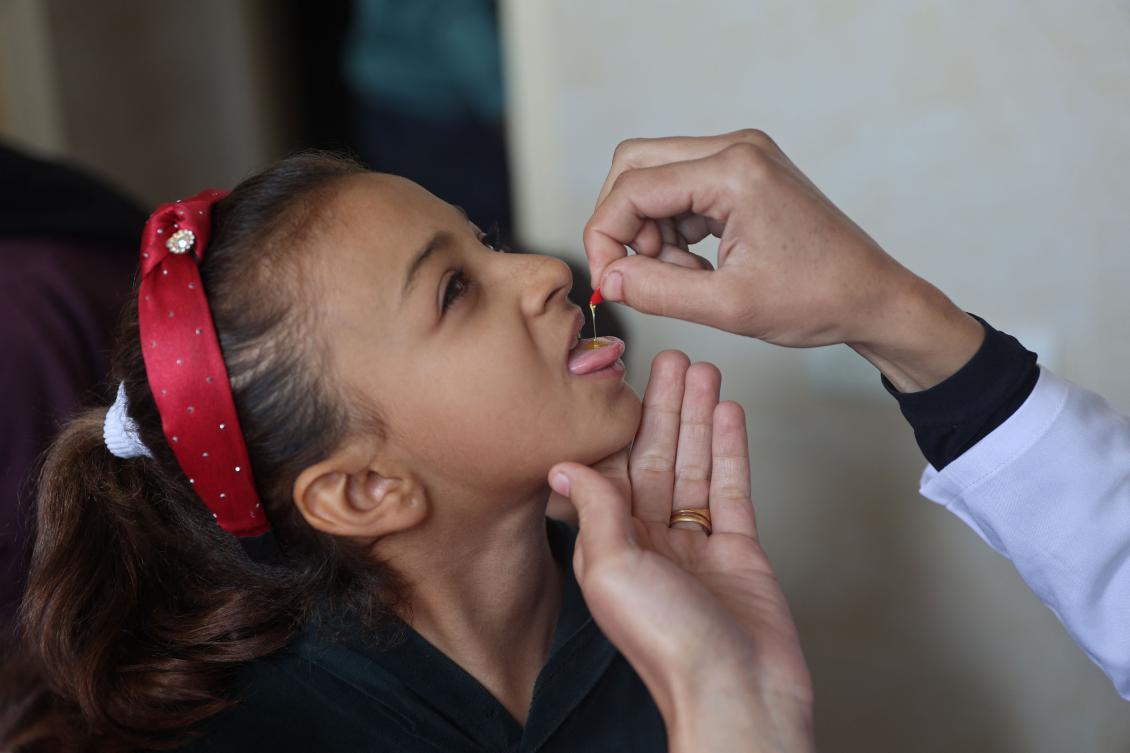 A medic administers a polio vaccine to a Palestinian child at Abdel Aziz Rantissi hospital in Gaza City’s Nasr district which was reopened on Nov. 2, 2024, after sustaining heavy damage in Israeli bombardment of the area amid the ongoing war in the Palestinian territory between Israel and Hamas. (AFP)