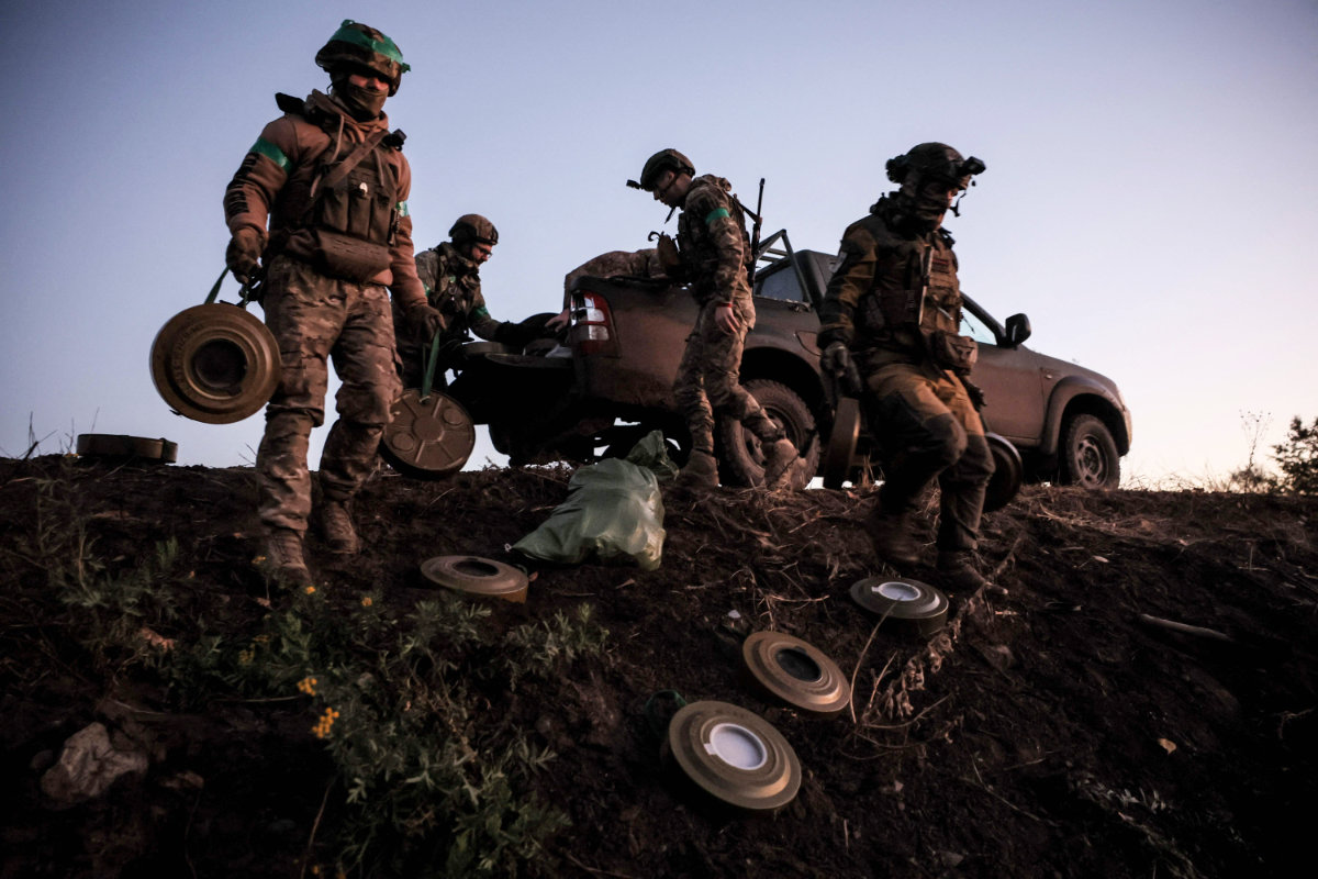 This handout photograph taken and released by Ukraine's 24th mechanized brigade on Oct. 30, 2024 shows troops laying out anti-tank landmines along the frontline in the Donetsk region, amid the Russian invasion in Ukraine. (AFP)