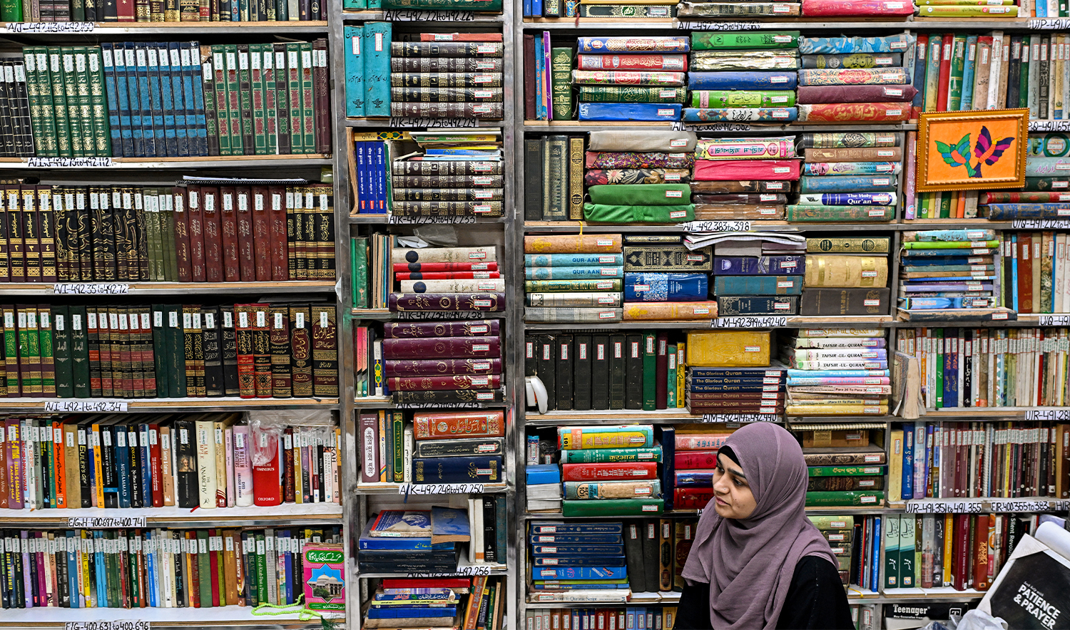 This photograph taken on October 22, 2024 shows a student sitting amid Urdu books stacked at the Hazrat Shah Waliullah public library, in Urdu Bazar in the old quarters of Delhi. (AFP)