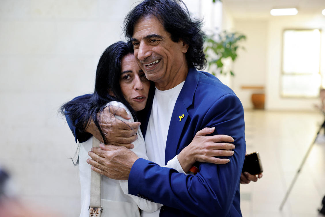 The father of hostage Idan Shtivi and the mother of hostage Matan Zangauker hug in court following a ruling on the lifting of a gag order on an ongoing investigation into the suspected leak of classified documents seized in Gaza by Netanyahu's circle, in Rishon Lezion, Israel, November 3, 2024. (Reuters)