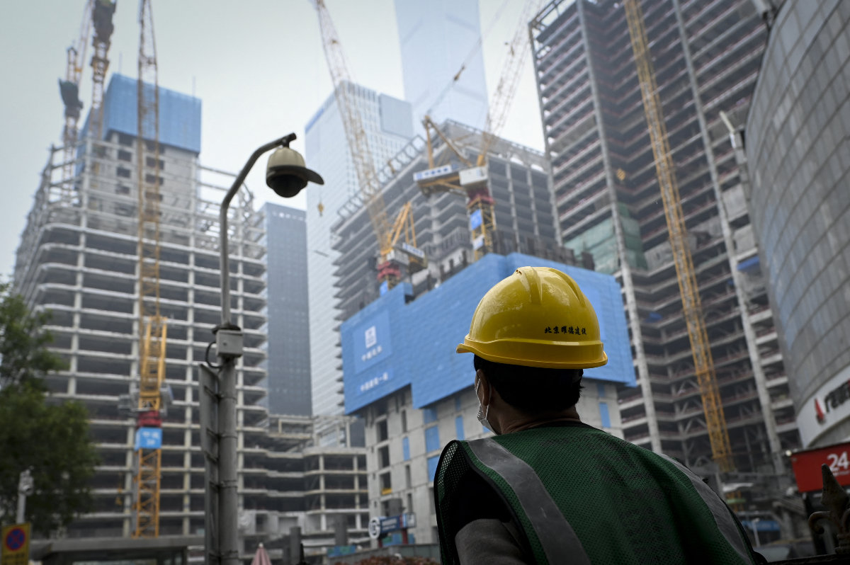 A worker walks past a construction site in Beijing on Oct. 31, 2024. (AFP)