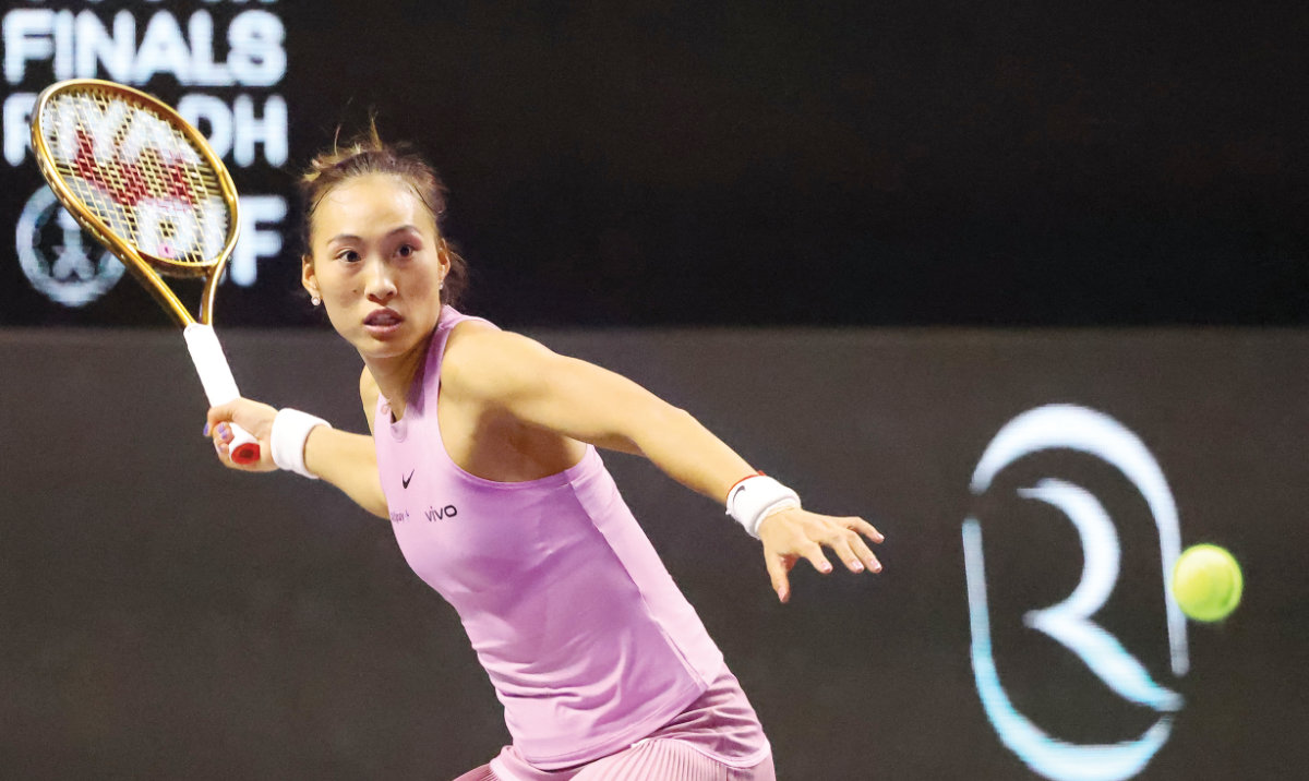 China’s Qinwen Zheng returns the ball to Kazakhstan’s Elena Rybakina during their women’s singles tennis match at the WTA Finals Championship in Riyadh on Monday. (AFP)