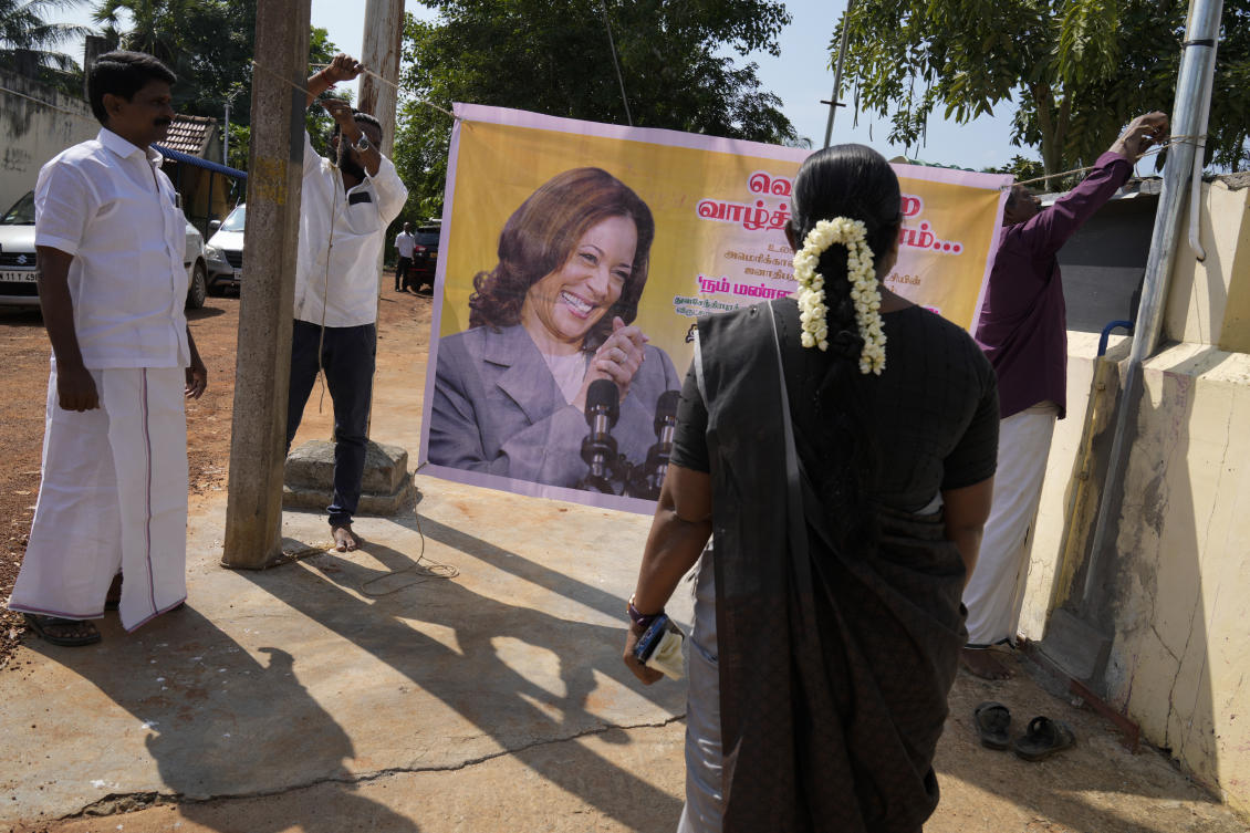 Villagers tie a banner featuring Democratic presidential nominee Vice President Kamala Harris outside a temple in Thulasendrapuram, the ancestral village of Harris, in Tamil Nadu state, India, Tuesday, Nov. 5, 2024. (AP)