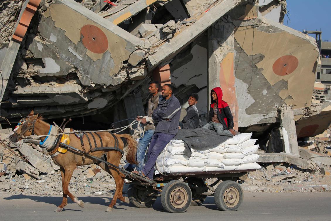 Palestinians transport bags of flour on a horse-drawn cart in the besieged Gaza Strip on November 5, 2024, amid the ongoing war between Israel and the Palestinian Hamas movement. (File/AFP)