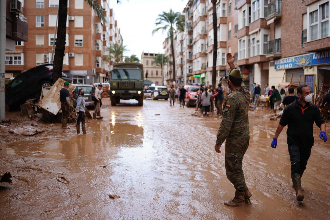 A soldier gestures to a military vehicle with water to be handed out in Paiporta, in the region of Valencia, eastern Spain, on Nov. 3, 2024, in the aftermath of devastating deadly floods. (AFP)