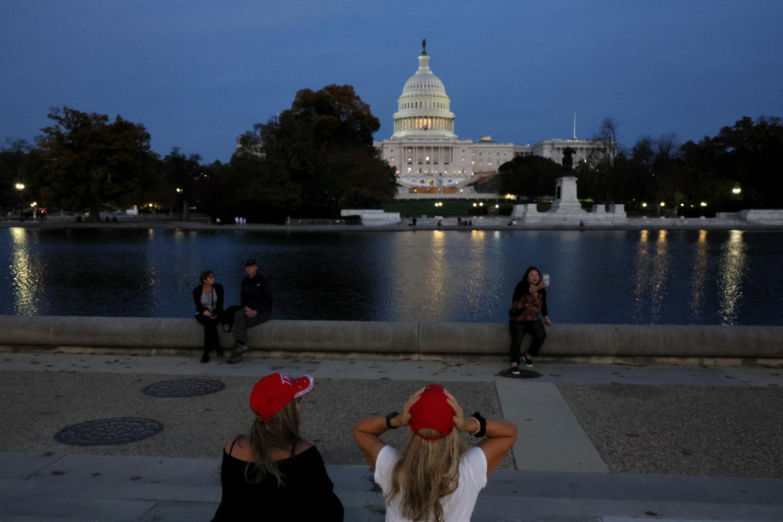 Supporters wearing Trump hats sit near the Capitol Reflecting Pool near the US Capitol building as the sun sets the day US President Elect Donald Trump was declared the winner of the presidential election. (Reuters)