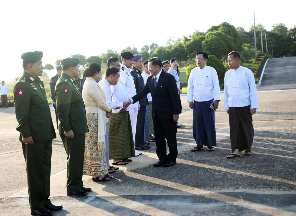 Myanmar junta chief Min Aung Hlaing, center, shakes hands with government officials prior to his departure to China at Naypyitaw on Nov. 5, 2024. (The Myanmar Military True News Information Team via AP)