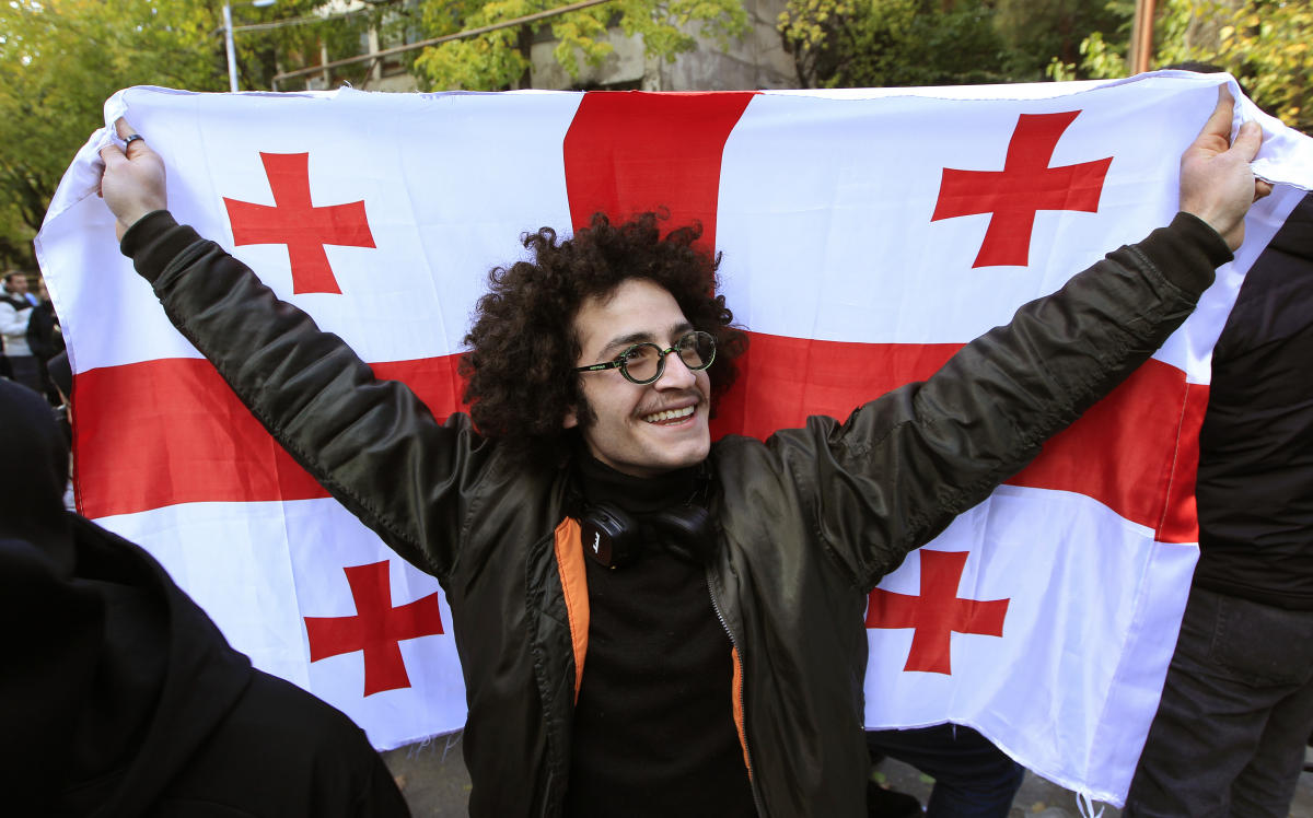 A protester holds a Georgian national flag during a rally against alleged violations in a recent parliamentary election in Tbilisi, Georgia, Tuesday, Nov. 5, 2024. (File/AP)