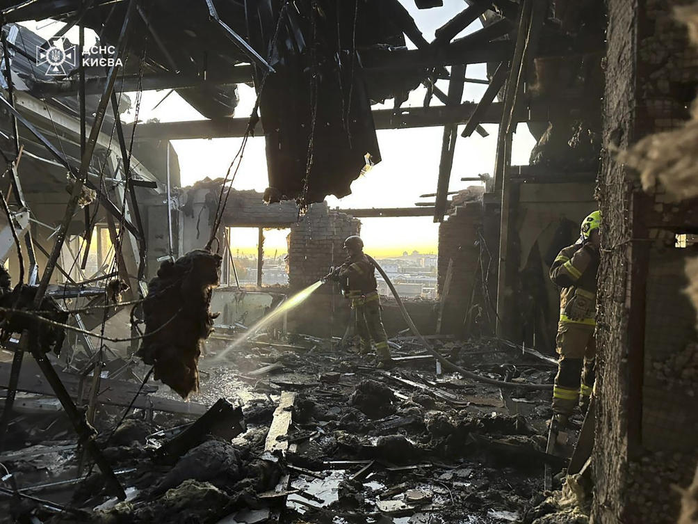 Above, a rescuer puts out a fire resulted from Russian drone attack in Kyiv, Ukraine on Nov. 7, 2024. (Ukrainian Emergency Service via AP)