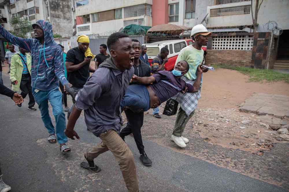 Several thousand people took to the streets on Thursday morning, with some dispersed by riot police using tear gas. Above, protesters carry a protester injured by a rubber bullet on Nov. 7, 2024. (AFP)