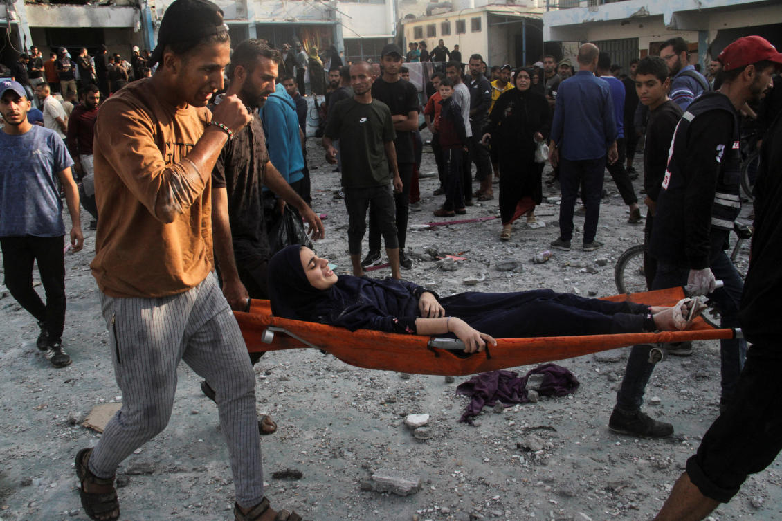 Palestinians carry an injured woman on a stretcher after a school sheltering displaced people was hit by an Israeli strike, at Beach camp in Gaza City Nov. 7, 2024. (Reuters)