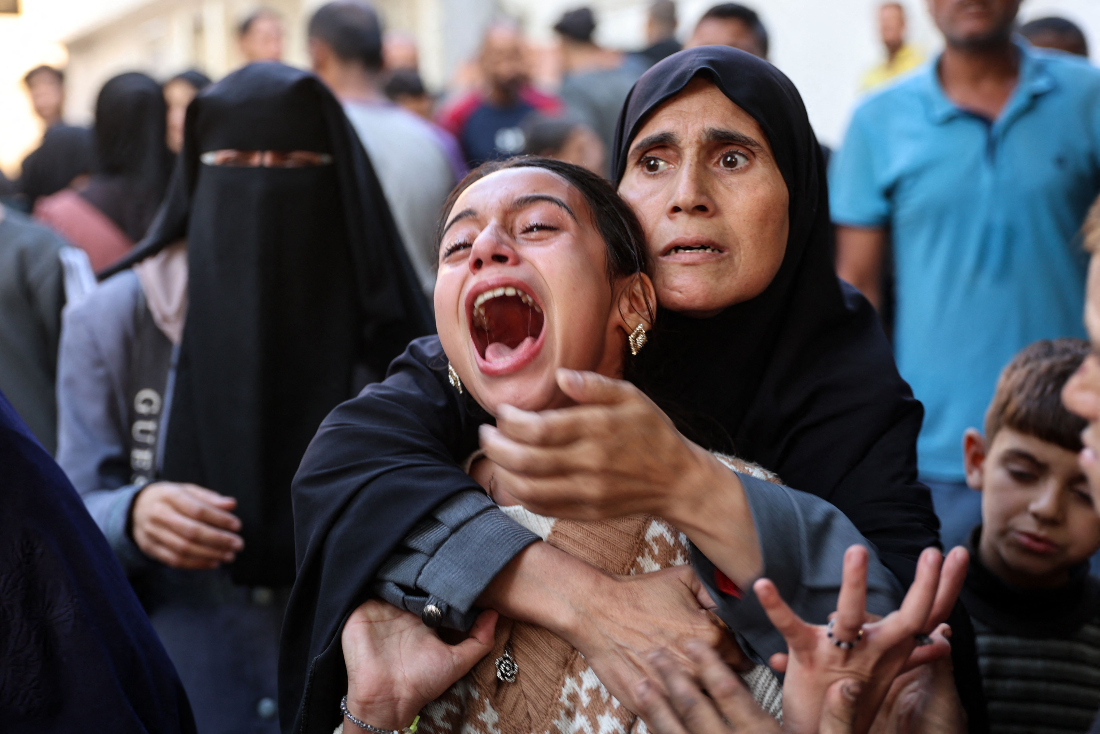 Young Palestinian girl reacts in the courtyard of the al-Shifa hospital in Gaza City after the bodies of victims were transported there, following an Israeli strike that hit a school-turned-shelter in the Al-Shati refugee camp amid the ongoing war between Israel and the Hamas militant group. (File/AFP)
