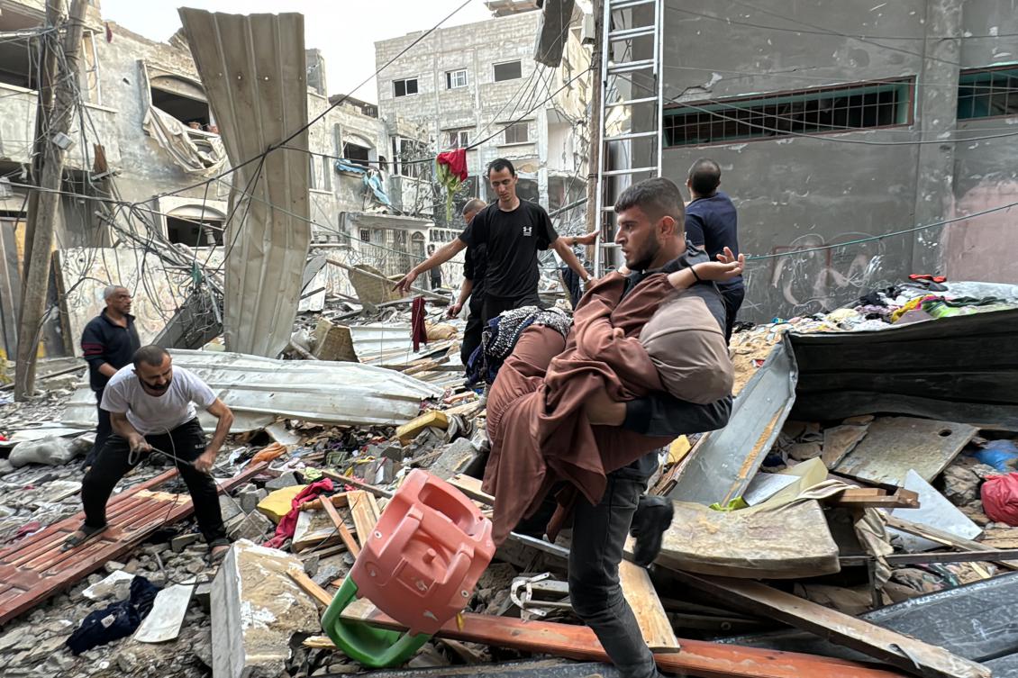 A Palestinian woman who lost her leg when her family home was hit in an Israeli strike in the Jabalia refugee camp in the northern Gaza Strip, is carried away on November 7, 2024. (AFP)