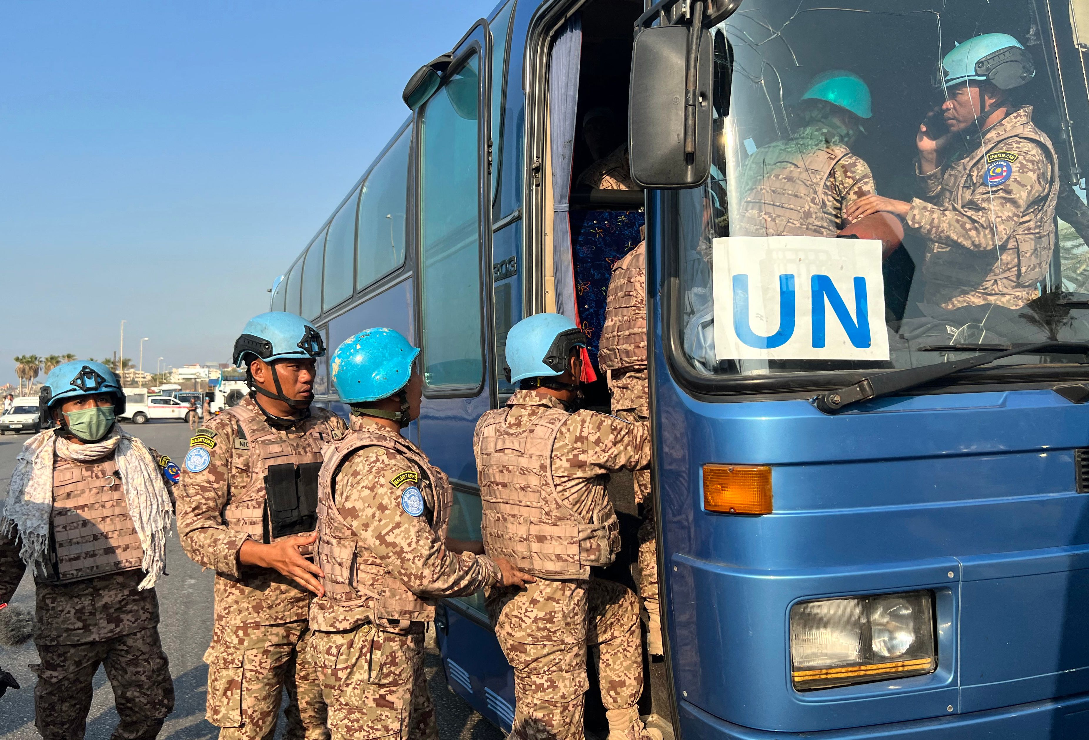 Members of the UNIFIL peacekeeping force enter a bus at the site of an Israeli strike at the northern entrance of the southern city of Sidon, on November 7, 2024, amid the ongoing war between Israel and Hezbollah. (AFP)
