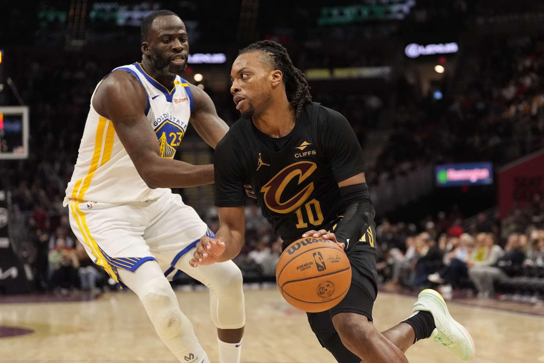 Cleveland Cavaliers guard Darius Garland drives past Golden State Warriors forward Draymond Green in the second half of an NBA basketball game Fridayin Cleveland. (AP)