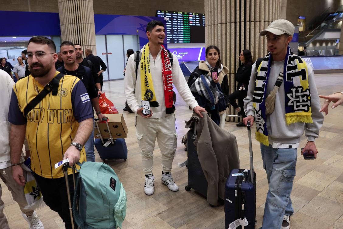 Fans of the Israeli football club Maccabi Tel-Aviv arrive at the Ben Gurion International Airport on the outskirts of Tel Aviv on November 8, 2024, upon returning from Amsterdam. (AFP)