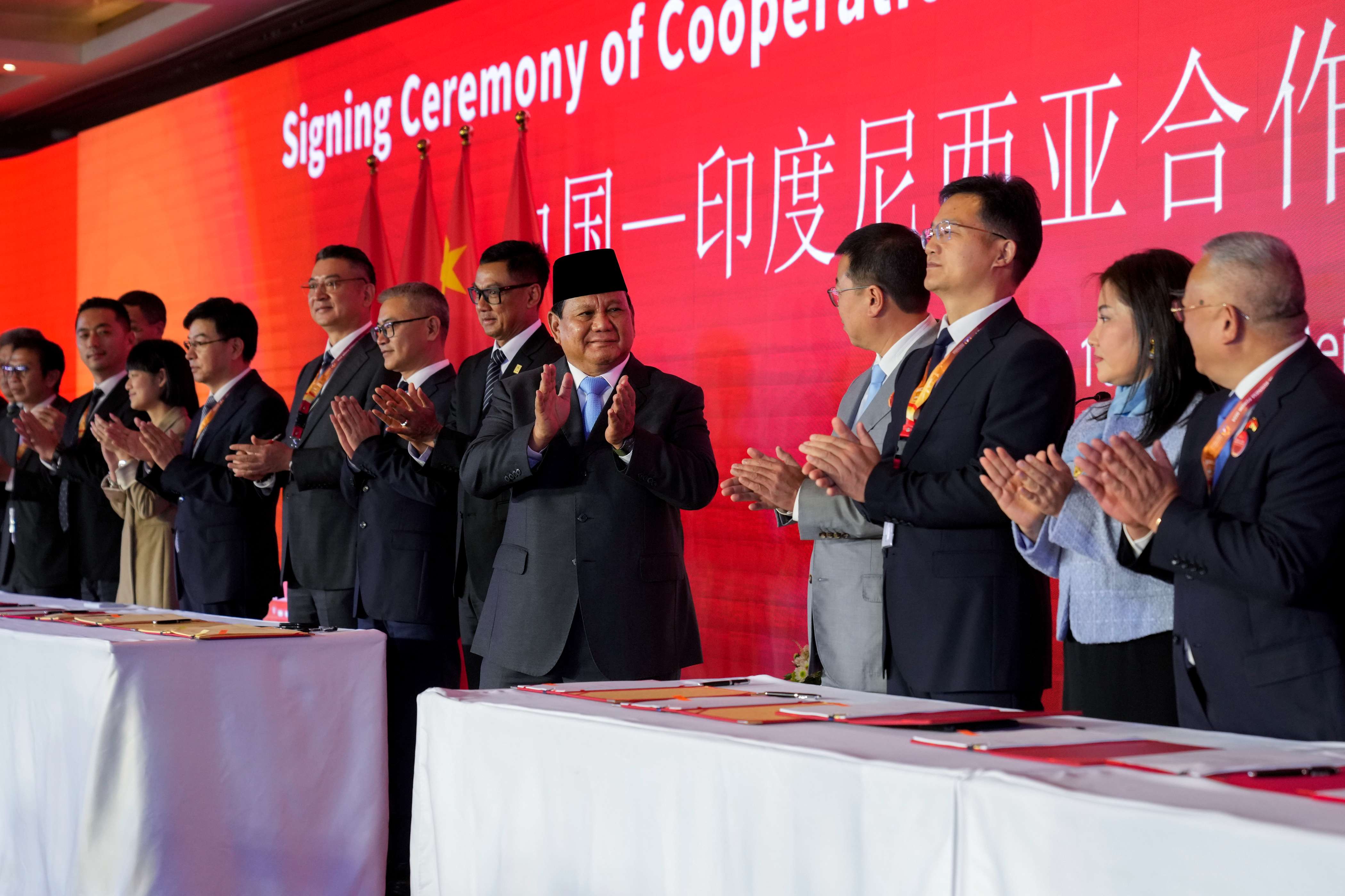 Indonesian President Prabowo Subianto, center, applauds after presiding over a signing ceremony of cooperation documents between Indonesia and China during the Indonesia-China Business Forum in Beijing, on Nov. 10, 2024. (AP Photo)