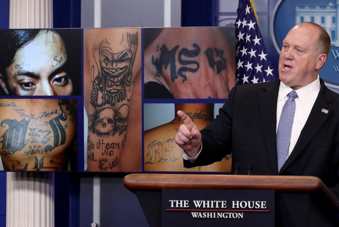 Above, Tom Homan, then director of Immigration and Customs Enforcement, answers questions in front of gang related photos from the MS-13 gang during a White House briefing on July 27, 2017. (Getty Images/AFP)