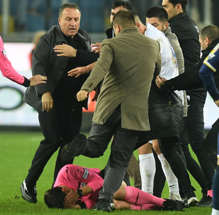Turkish referee Halil Umut Meler covers himself as Ankaragucu’s then-president Faruk Koca attacks him at the end of the Turkish Super Lig football match between MKA Ankaragucu and Caykur Rizespor on Dec. 11, 2023. (depo photos/AFP)