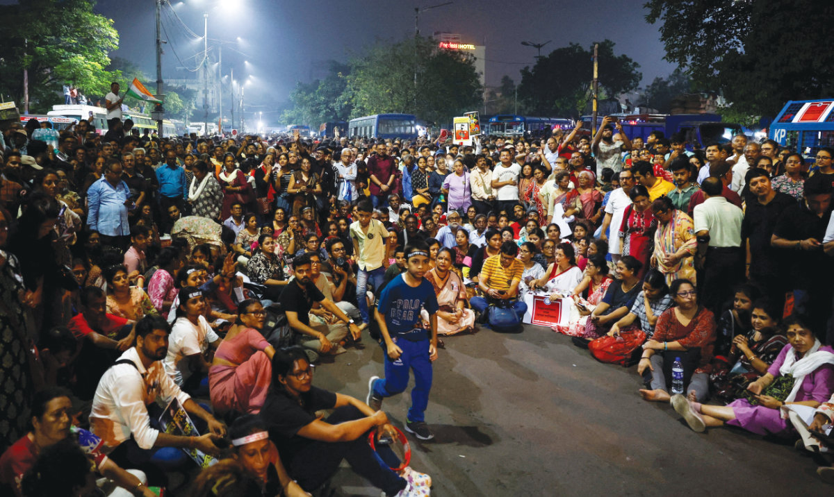 People sit and chant slogans as they attend a protest condemning the rape and murder of a trainee medic at a government-run hospital, in Kolkata, India, Oct. 15. (Reuters/File)