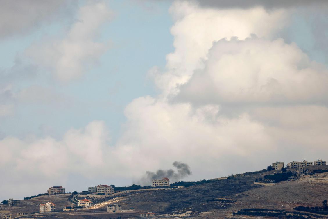 A picture taken from northern Israel along the border with Lebanon shows smoke billowing behind a building following Israeli bombardment in the southern Lebanese village of Maroun Al-Ras on Nov. 12, 2024. (AFP)