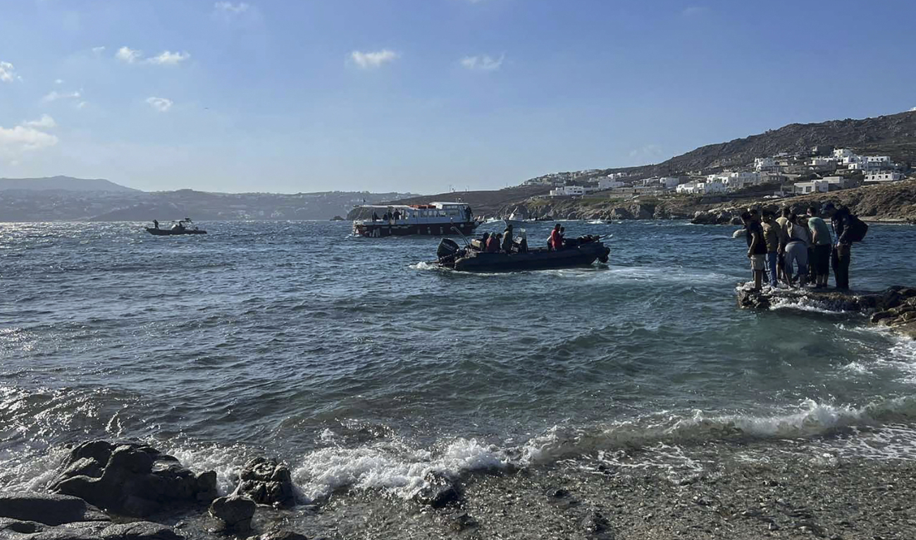 This handout picture released by the Hellenic Coast Guard on June 19, 2022 shows rescued migrants during their transfer to Mykonos island. (AFP/File)