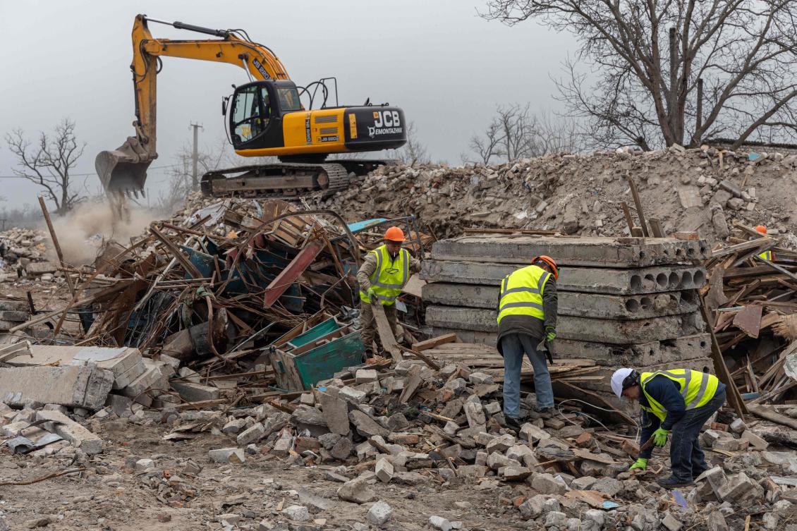 Above, workers for French company Neo-Eco clear debris of a school in the village of Lyubomyrivka, Mykolaiv region on Feb. 14, 2024. The company abandoned a project in Ukraine due to corruption. (AFP)