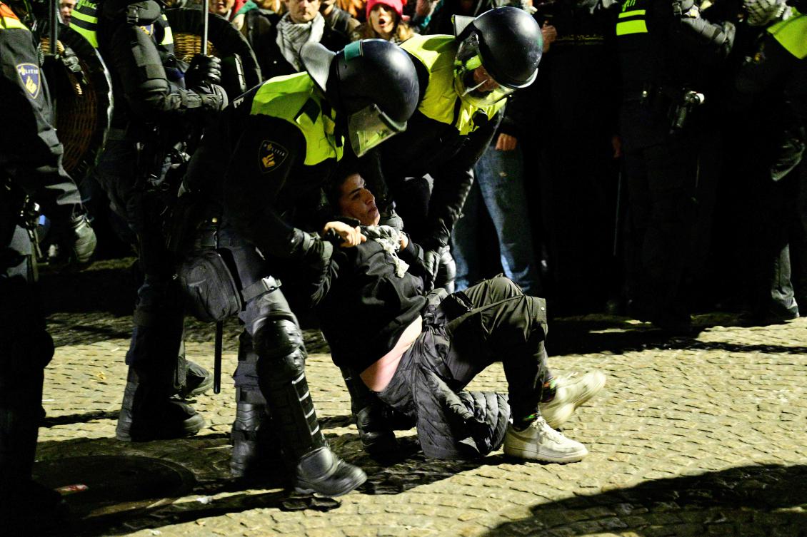 Police officers detain a protester during an unauthorized pro-Palestinian demonstration on Dam Square in Amsterdam on November 13, 2024. (AFP)