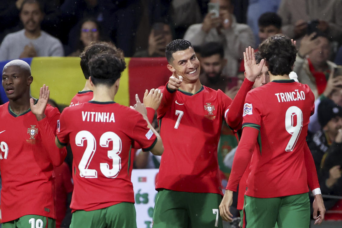 Portuguese players celebrate during a match against Poland in Porto. (AP)
