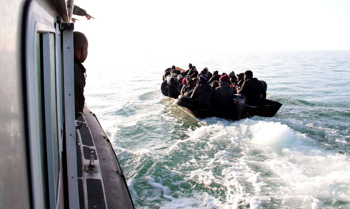 The Tunisian Maritime National Guard approaches a boat at sea carrying people from different African countries seeking to get to Italy, near the coast of Sfax, Tunisia. (AP/File)