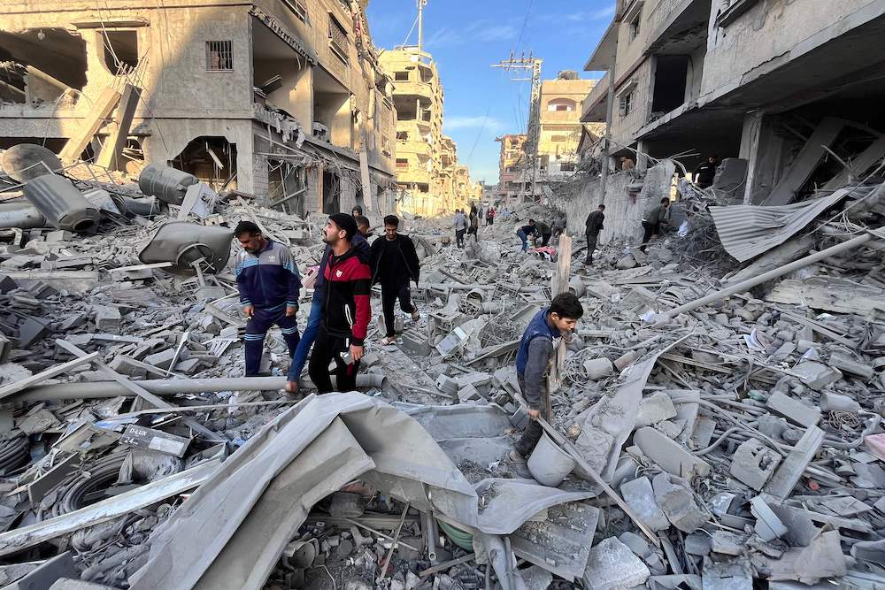 People check the rubble of a building hit in an overnight Israeli strike in Beit Lahya in the northern Gaza Strip on November 17. (AFP)