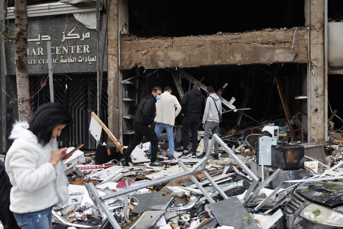 People inspect the damage to a building, targeted in an Israeli airstrike the previous day, in Beirut’s Mar Elias Street on November 18, 2024, amid the ongoing war between Israel and Hezbollah. (AFP)