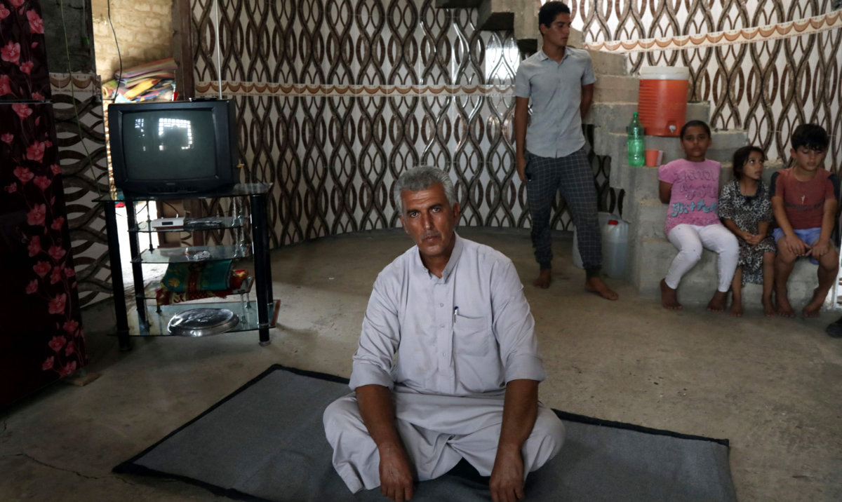 Moaz Fadhil, 53, sits at the Hasan Shami village in northern Iraq, which was damaged during the 2014 attacks by Daesh fighters and the battles that followed, some 40 kilometers west of Arbil in northern Iraq, on September 17, 2024. (AFP)