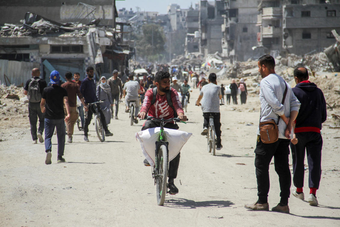 FILE PHOTO: A Palestinian man transports a bag of flour on his bicycle as others struggle to receive their portion of aid, amid a widespread hunger, as the conflict between Israel and the Palestinian Islamist group Hamas continues, in Gaza City. (REUTERS)