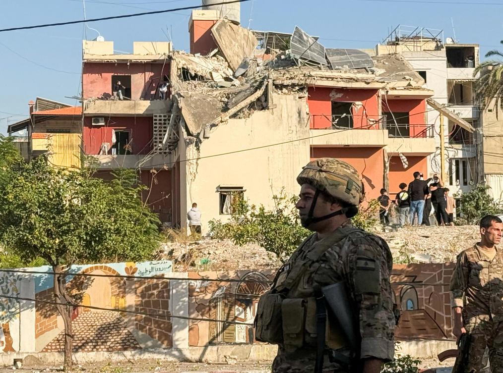 Lebanese army soldiers and people stand near the site of an Israeli strike in Sidon, Lebanon on Oct. 27, 2024. (Reuters/File)
