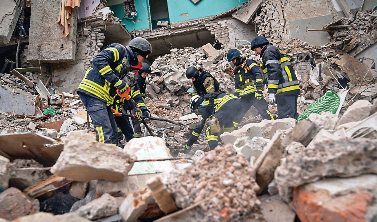 Rescuers work at the site of a residential building, which was hit by a drone strike amid Russia’s attack on Hlukhiv, Ukraine, on Tuesday. (Reuters)
