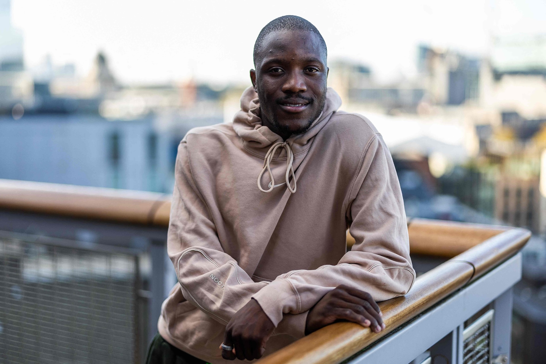 Botswana’s sprinter and 2024 Paris Olympic gold medalist for the men’s 200m, Letsile Tebogo, poses on a balcony in central London, on Nov. 14, 2024 during an interview. After his Olympic success he aims to unleash the “deadly” untapped potential of athletes from the continent. (AFP)