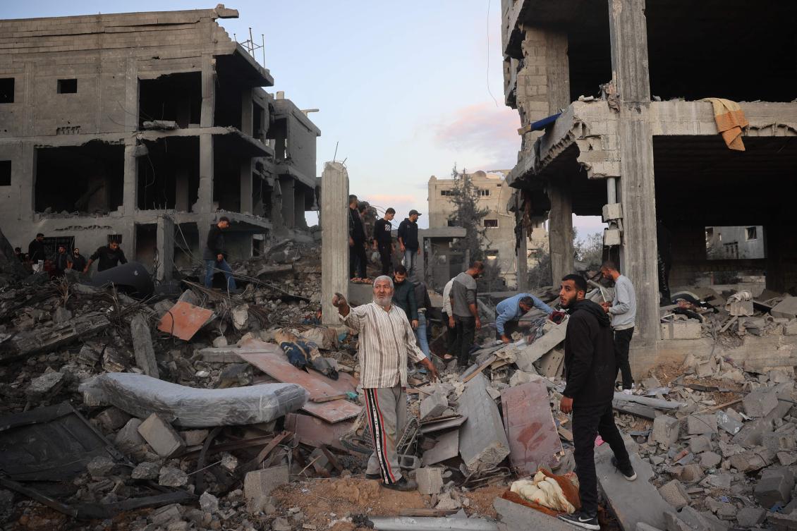 Palestinians inspect the damage at the site of an Israeli airstrike on the Bureij refugee camp in the central Gaza Strip on November 19, 2024, amid the ongoing war between Israel and the Hamas militant group. (AFP)