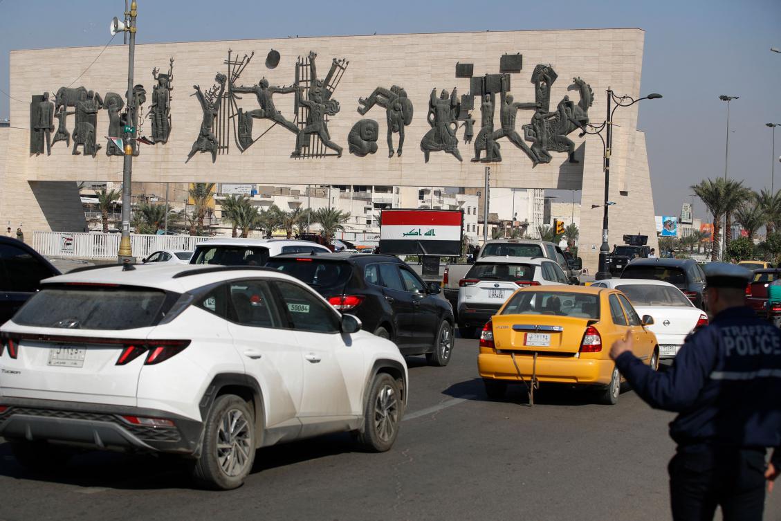 A traffice policeman directs cars driving through Baghdad's main Tahrir Square on November 19, 2024. For the first time in nearly 40 years Iraq this week will conduct a nationwide census, undertaking a tally long delayed by repeated outbreaks of war and unrest. (AFP)