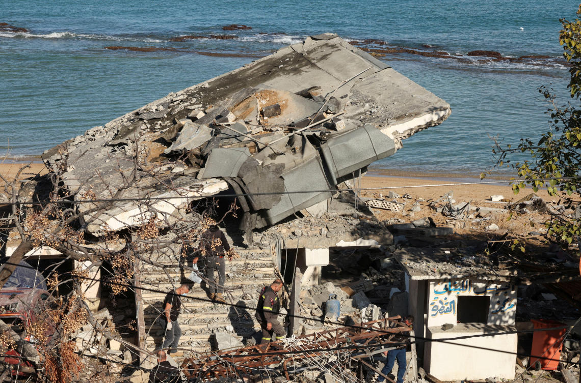 People inspect a damaged site in the aftermath of an Israeli strike that hit an army post according to a Lebanese army statement, amid ongoing hostilities between Hezbollah and Israeli forces, in the town of Sarafand, southern Lebanon, November 20, 2024. (Reuters)