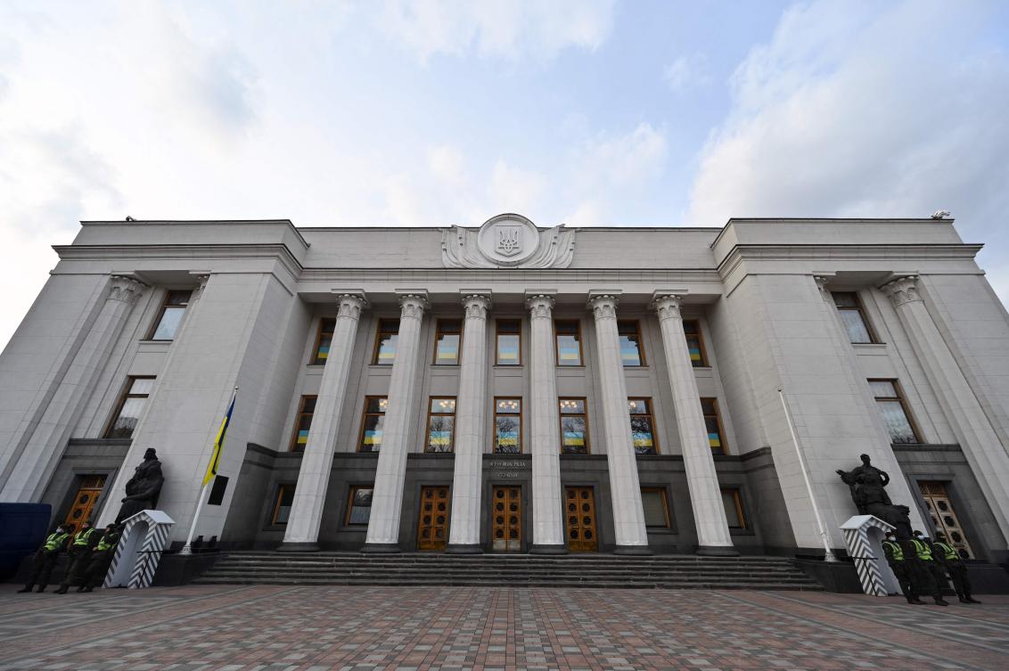 Above, National Guard servicemen stand guard outside the Ukrainian Parliament on Feb. 23, 2022. (AFP)
