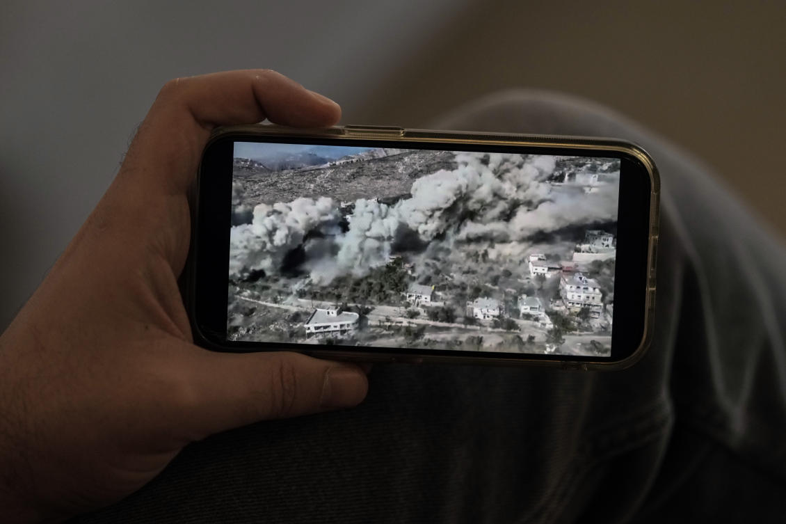 Lubnan Baalbaki, conductor of the Lebanese Philharmonic Orchestra, shows a video released by the Israeli army as they blew up his village of Odeiseh. (AP)