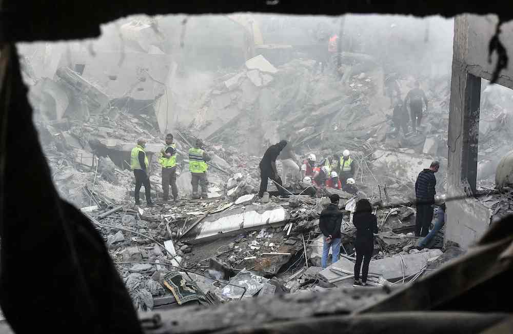Rescuers sift through the rubble of a levelled building, following an overnight Israeli airstrike that targeted Beirut’s Basta Al-Fawqa neighborhood on Nov. 23, 2024. (AFP)