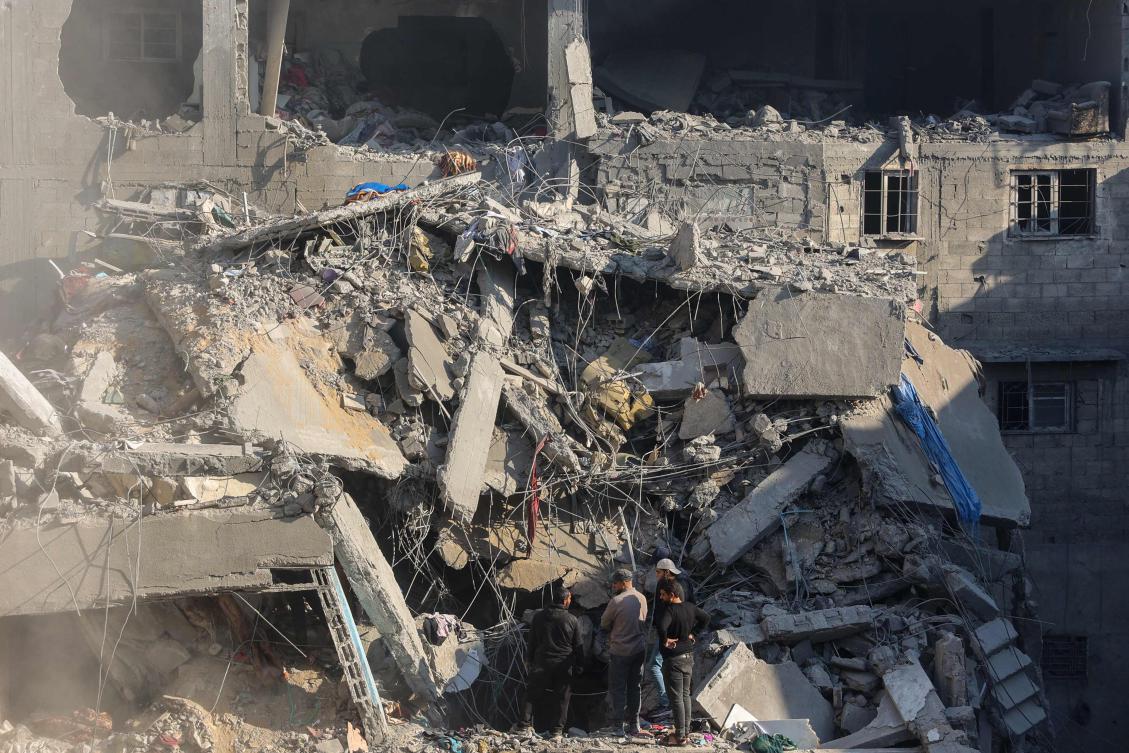 Palestinians check the rubble of a building in the aftermath of an Israeli strike south of Gaza City on November 22, 2024, as the war between Israel and Hezbollah continues. (Photo by Omar AL-QATTAA / AFP)