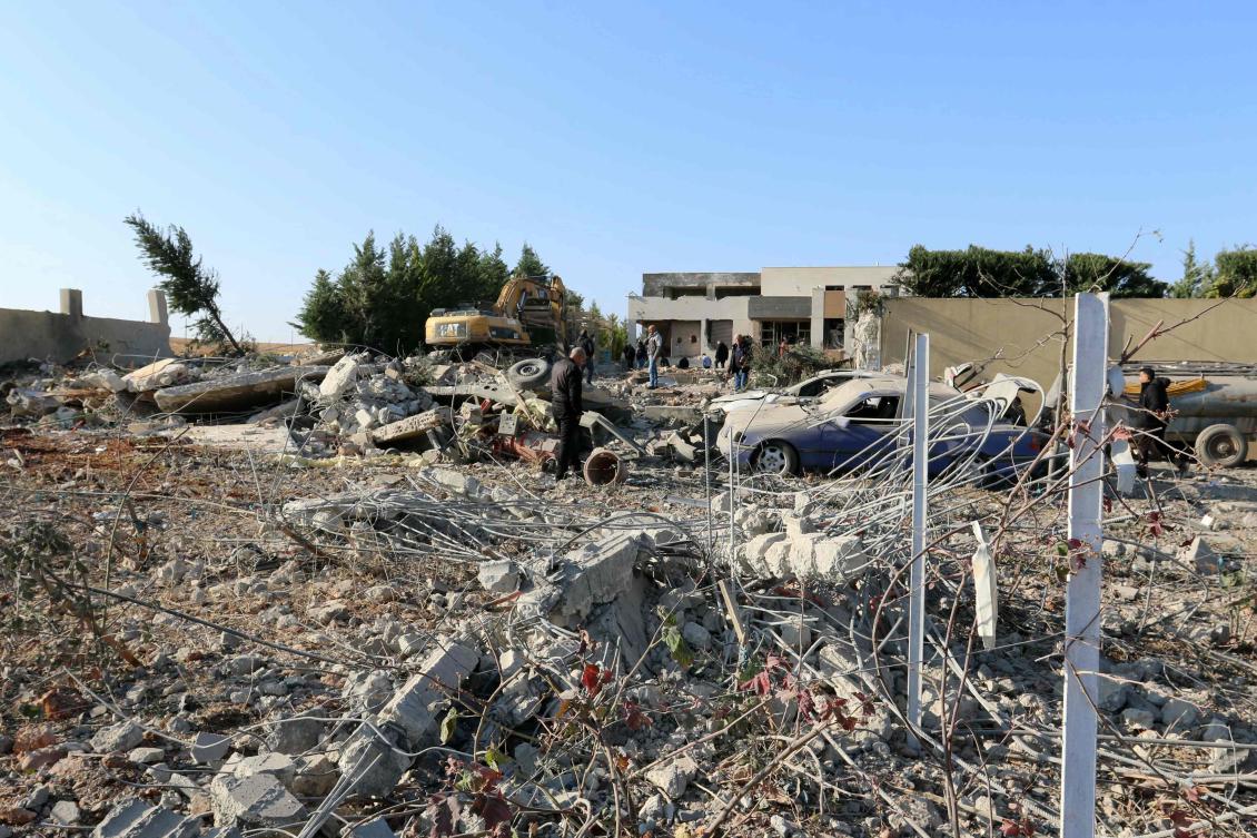 Workers remove the rubble from the site of an overnight Israeli airstrike that hit the residence of the director of a hospital in Baalbeck, in the eastern Lebanese Bekaa Valley on Nov. 23, 2024. (AFP)