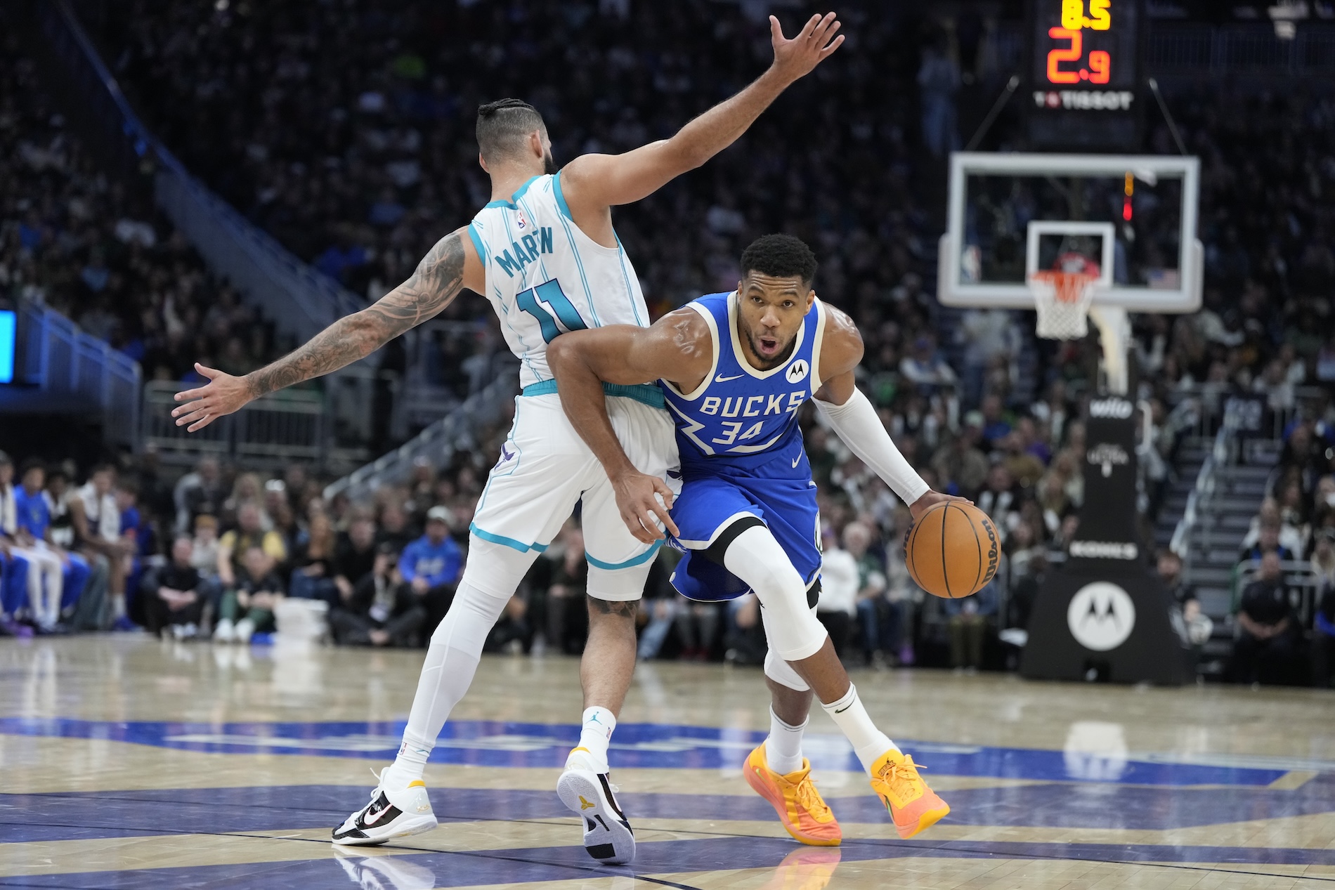 Milwaukee Bucks’ Giannis Antetokounmpo gets past Charlotte Hornets’ Cody Martin during the second half of an NBA basketball game Saturday in Milwaukee. The Bucks won 125-119. (AP)