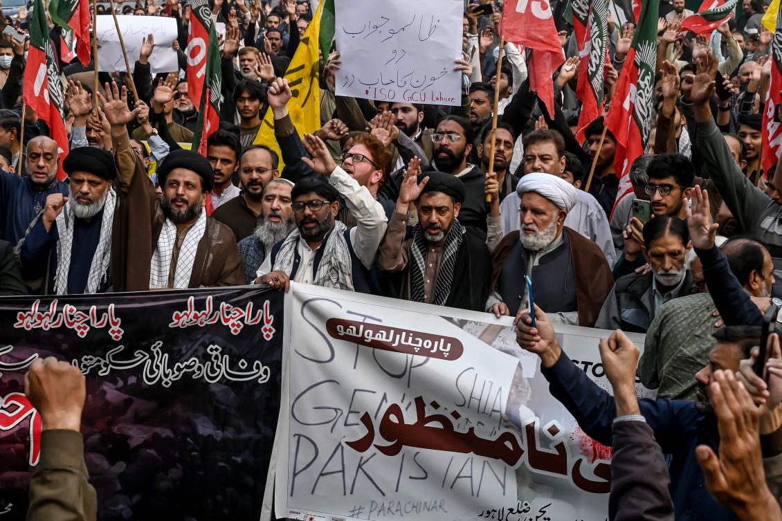 Shiite Muslims hold placards and shout slogans during a protest march against the sectarian attacks in Kurram district in Parachinar, the mountainous Khyber Pakhtunkhwa province, in Lahore on November 22, 2024. (AFP)