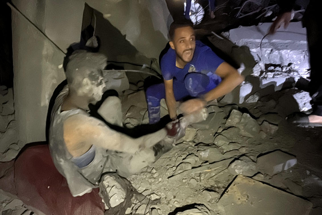 A man shouts as he pulls a survivor from the rubble of a building following an Israeli strike near the Kamal Adwan hospital in Beit Lahia, in the northern Gaza Strip, early on November 21, 2024, as the war between Israel and Palestinian Hamas.(AFP)