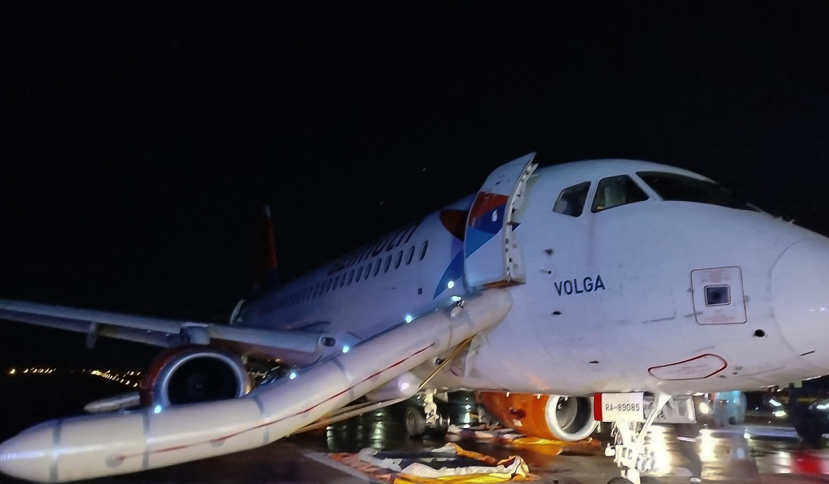 This photograph taken and released on November 24, 2024 by Turkish news agency DHA (Demiroren News Agency) shows the Russian Azimut airlines Sukkohoi Superjet 100-95RL passenger airplane after the fire on one of its engines was set off and 79 passengers were evacuated via emergency slides from the aircraft on the tarmac of Antalya Airport. (AFP)