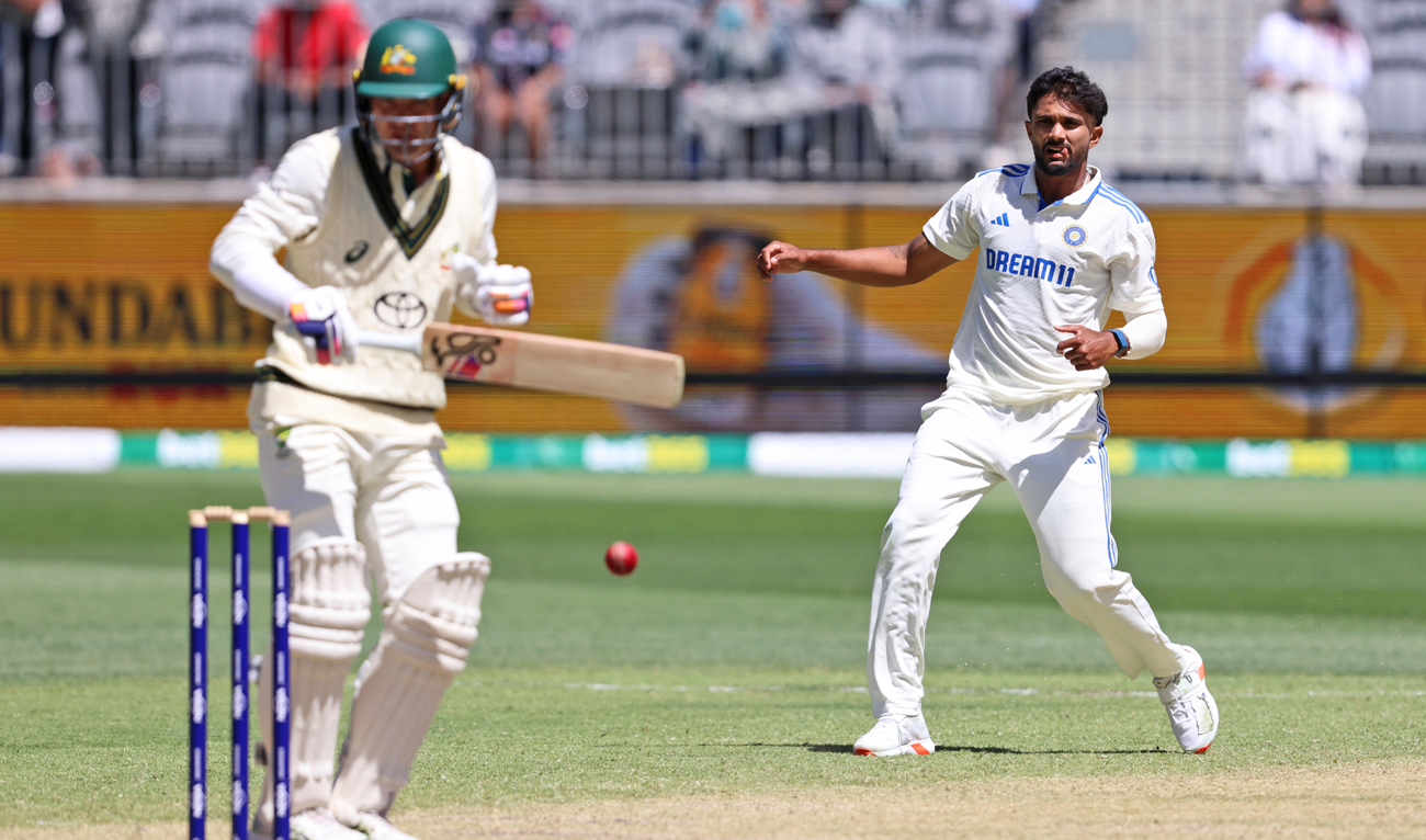 India’s Nitish Kumar Reddy, right, throws the ball at the stumps but catches Australia’s Alex Carey on the fourth day of the first cricket test between Australia and India in Perth on November 25, 2024. (AP)